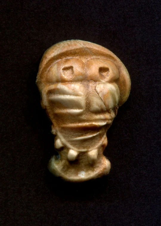 a clay figurine is shown on a black background