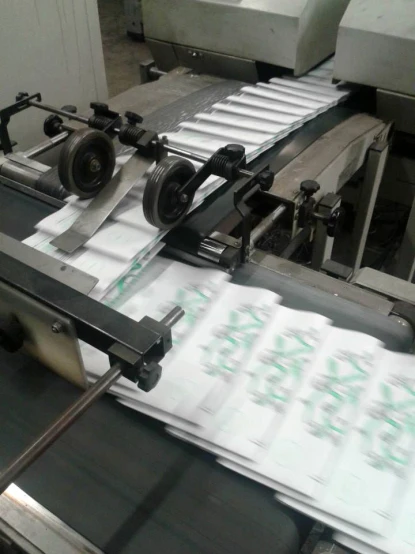 a machine with some papers running on it