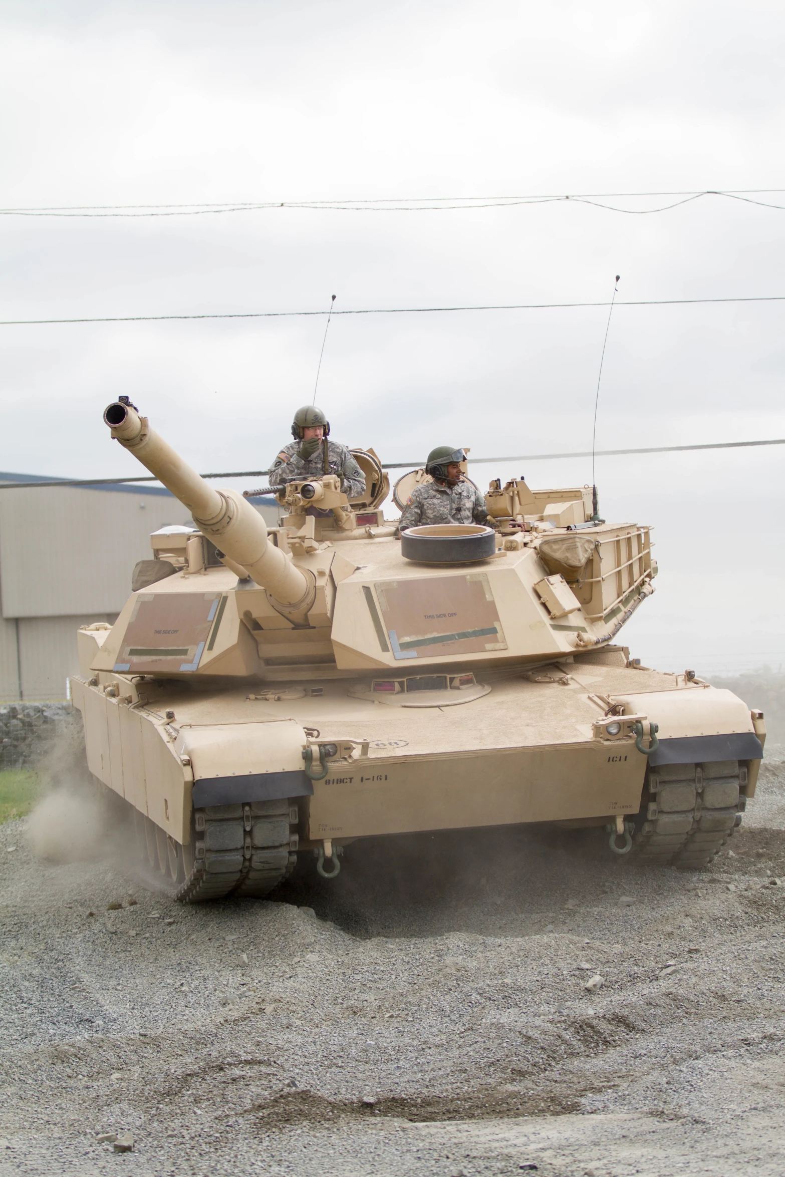 a couple of men that are standing next to a tank