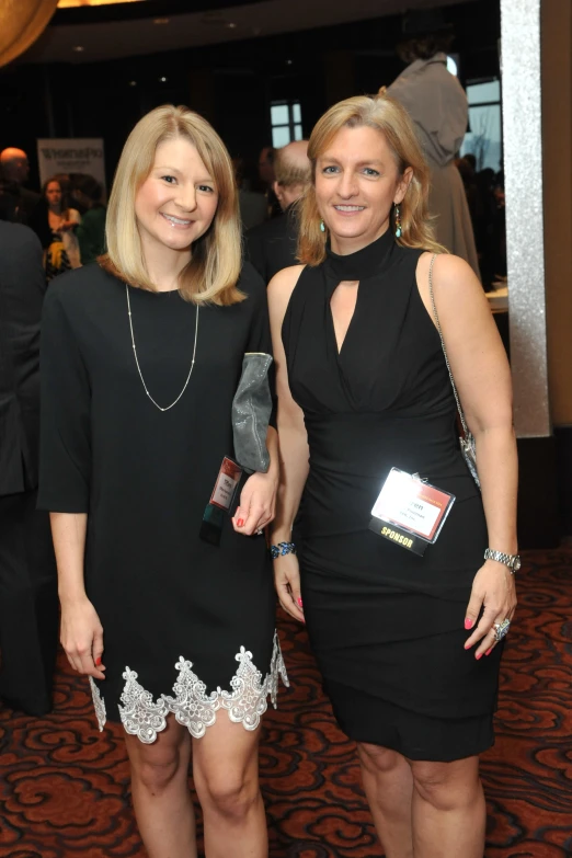 two women smiling and posing for the camera