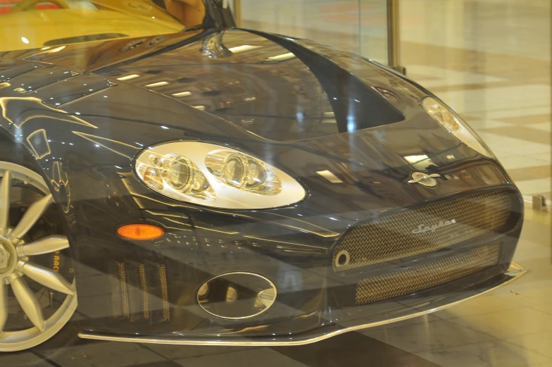 an interesting, shiny looking sports car sits on display