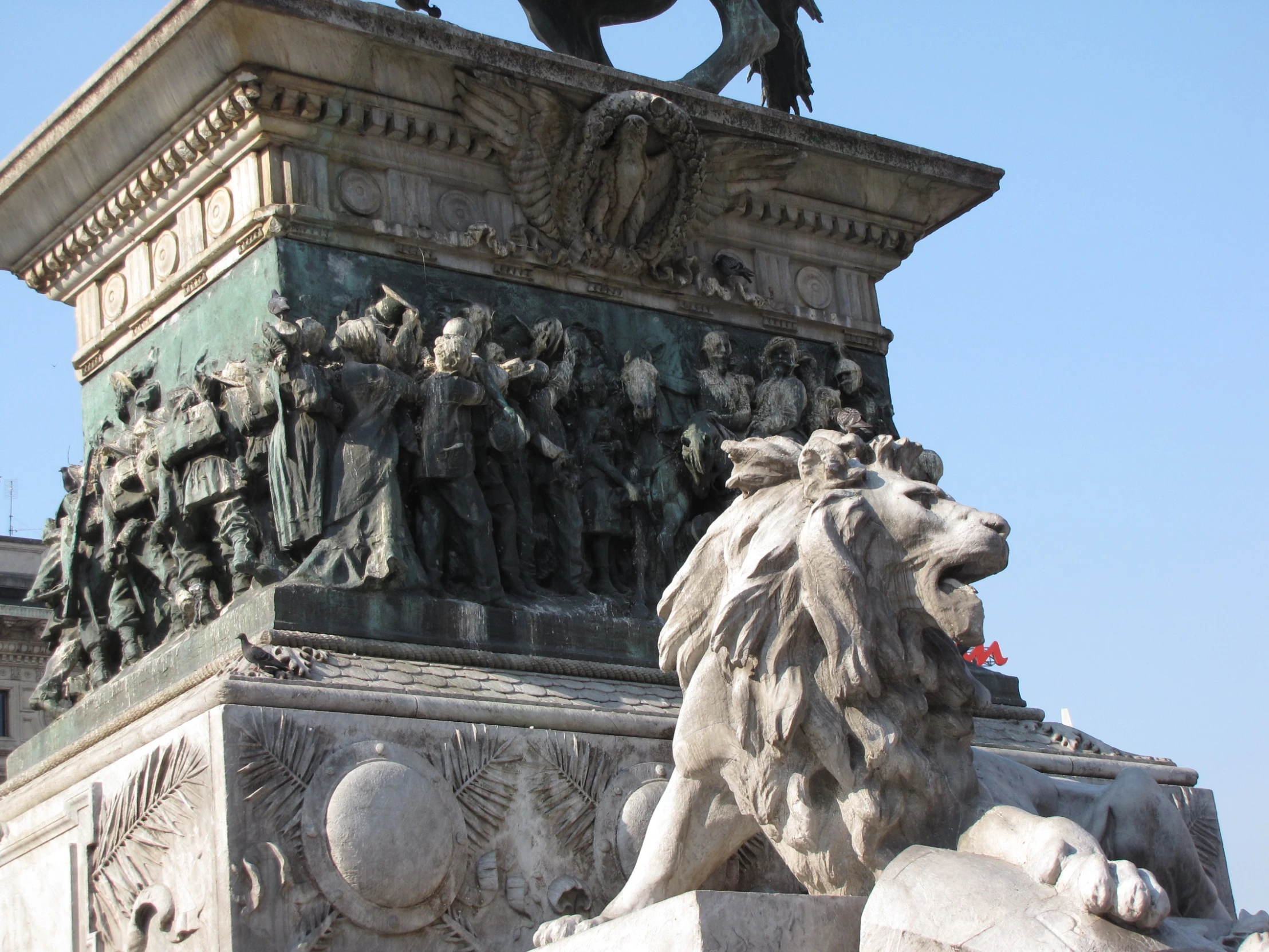 a statue of a lion on top of a big building