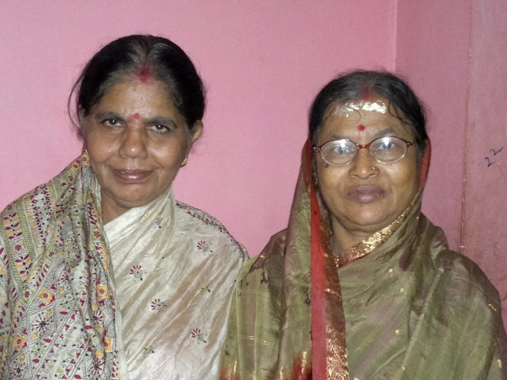 two women are dressed up and posing for the camera