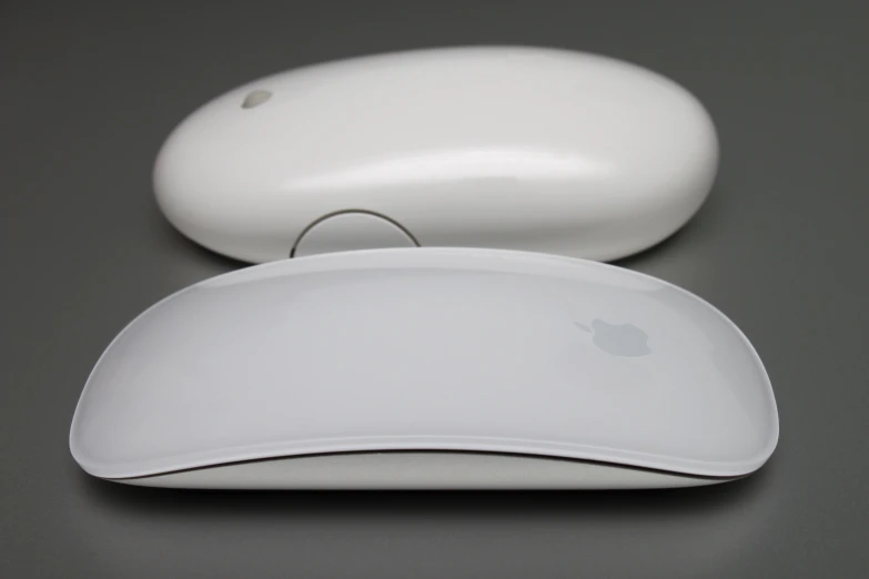 a pair of computer mouses on a table