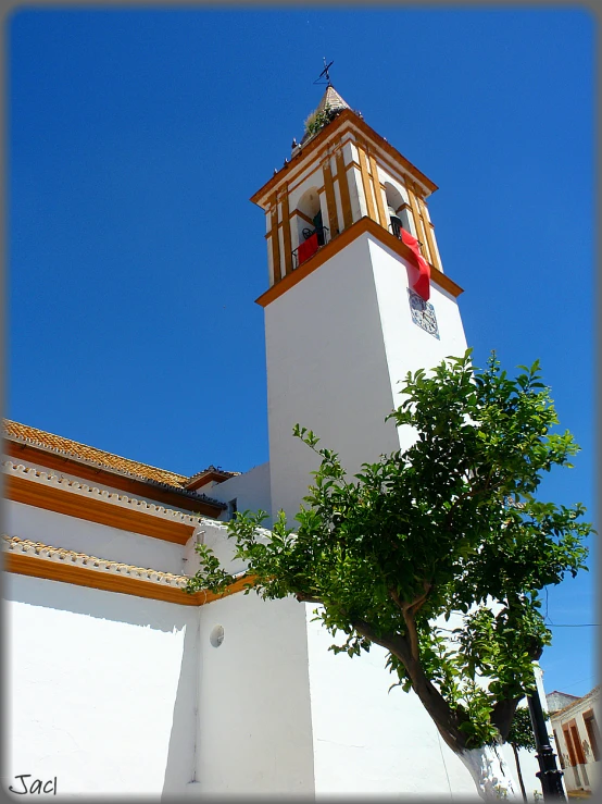 the large clock tower is very high in the blue sky