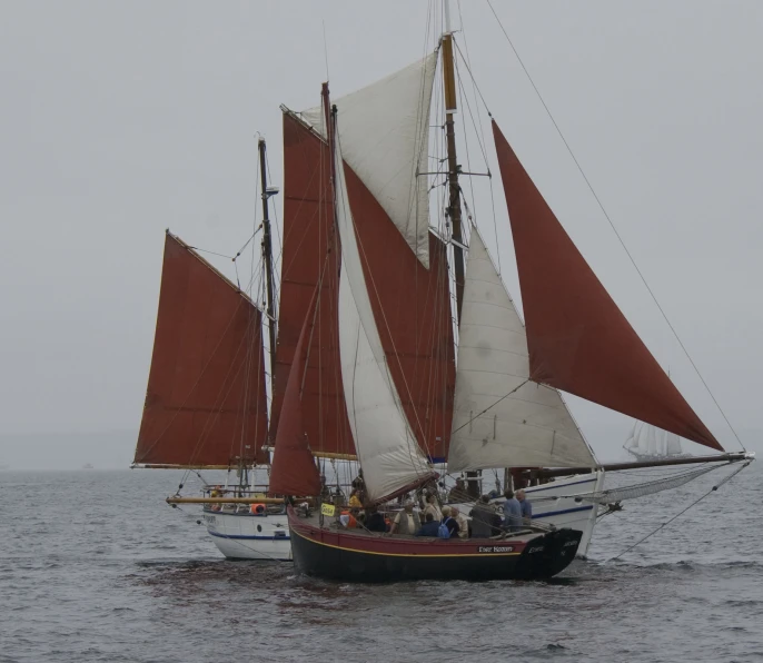 the three sailing boats are going along in the water