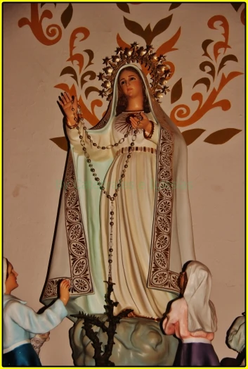 statue of mary of guadalupe with boy holding her hand