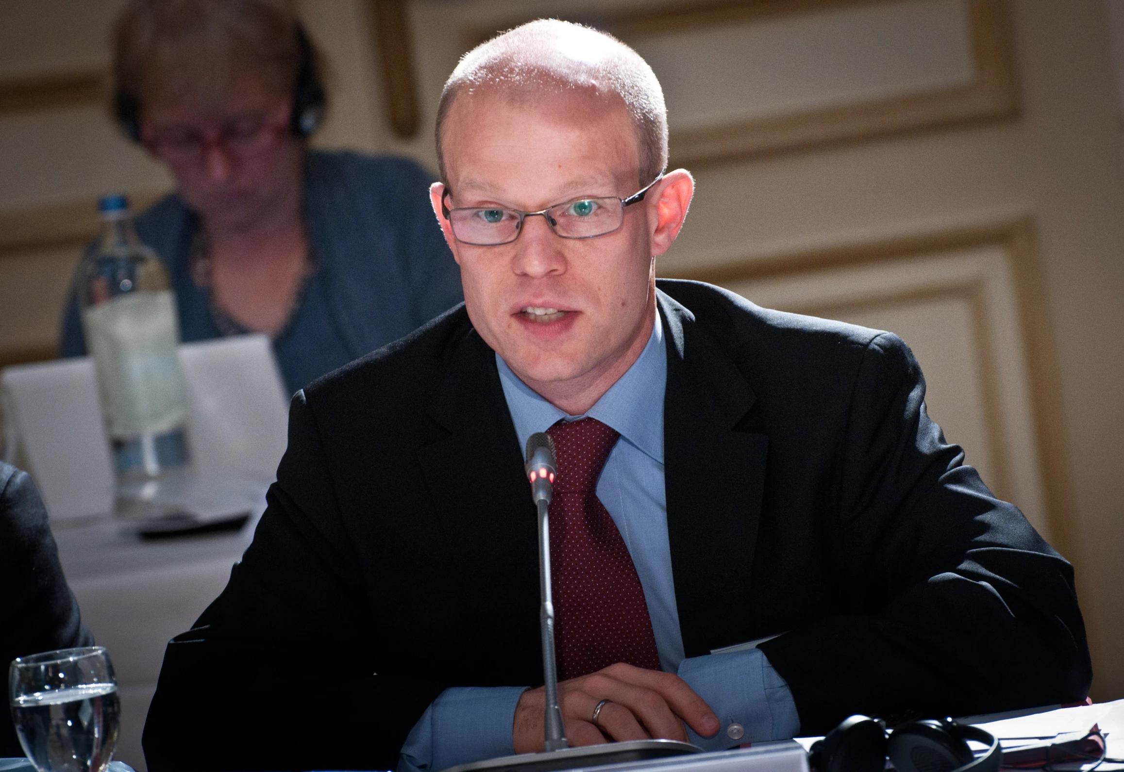 a man is sitting at a table and talking