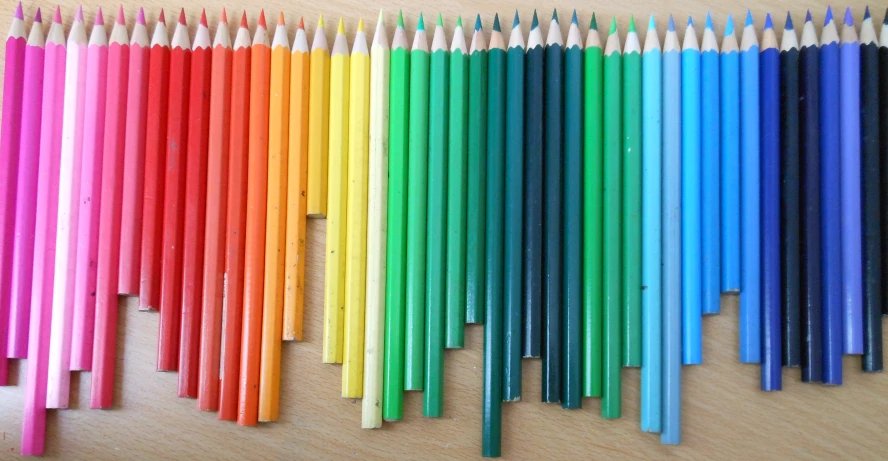 several rows of colored pencils are lined up