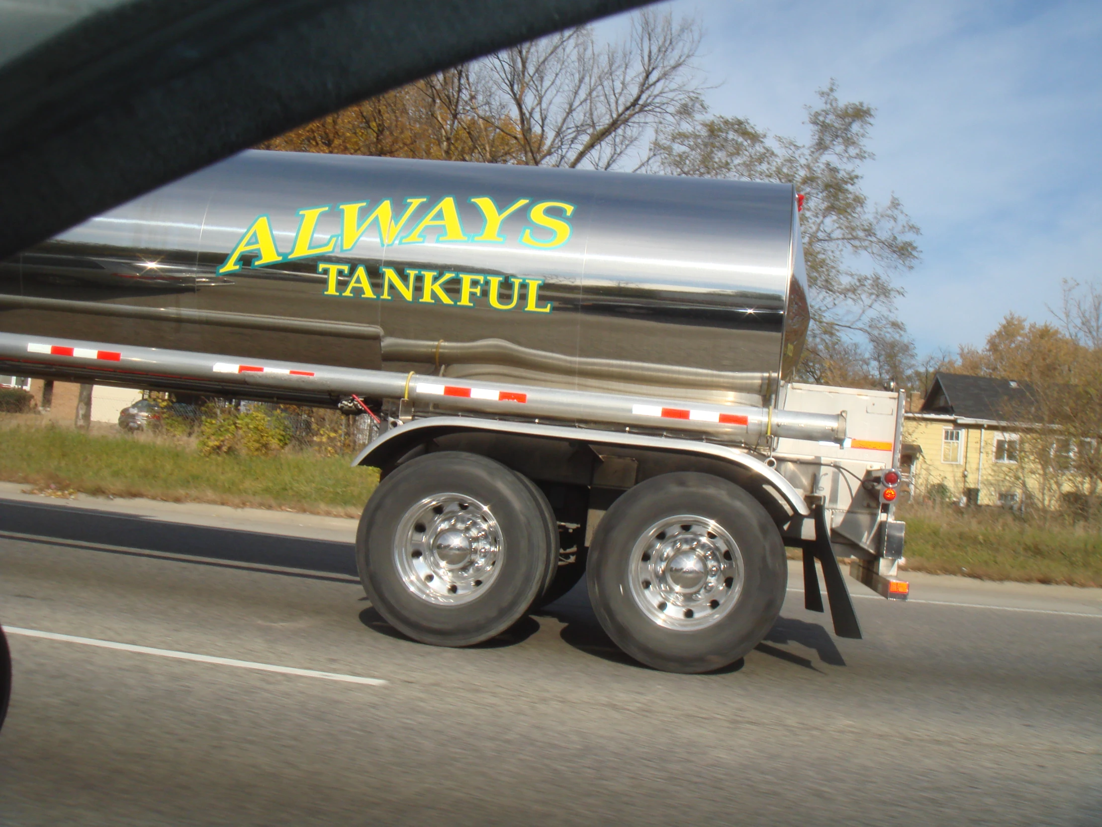 a semi - trailer driving down a city street