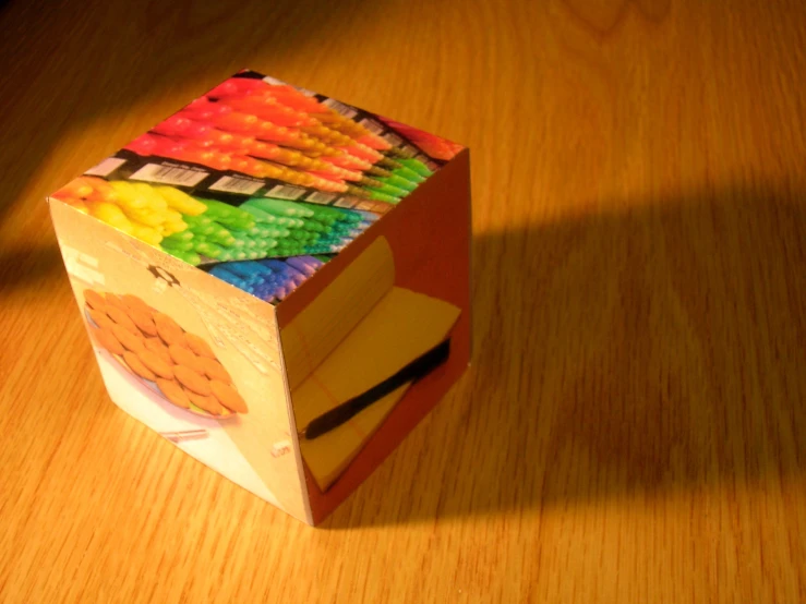 a small box of colorful pencils on a table