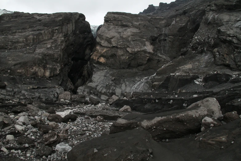 rocks and rock beach next to a mountain