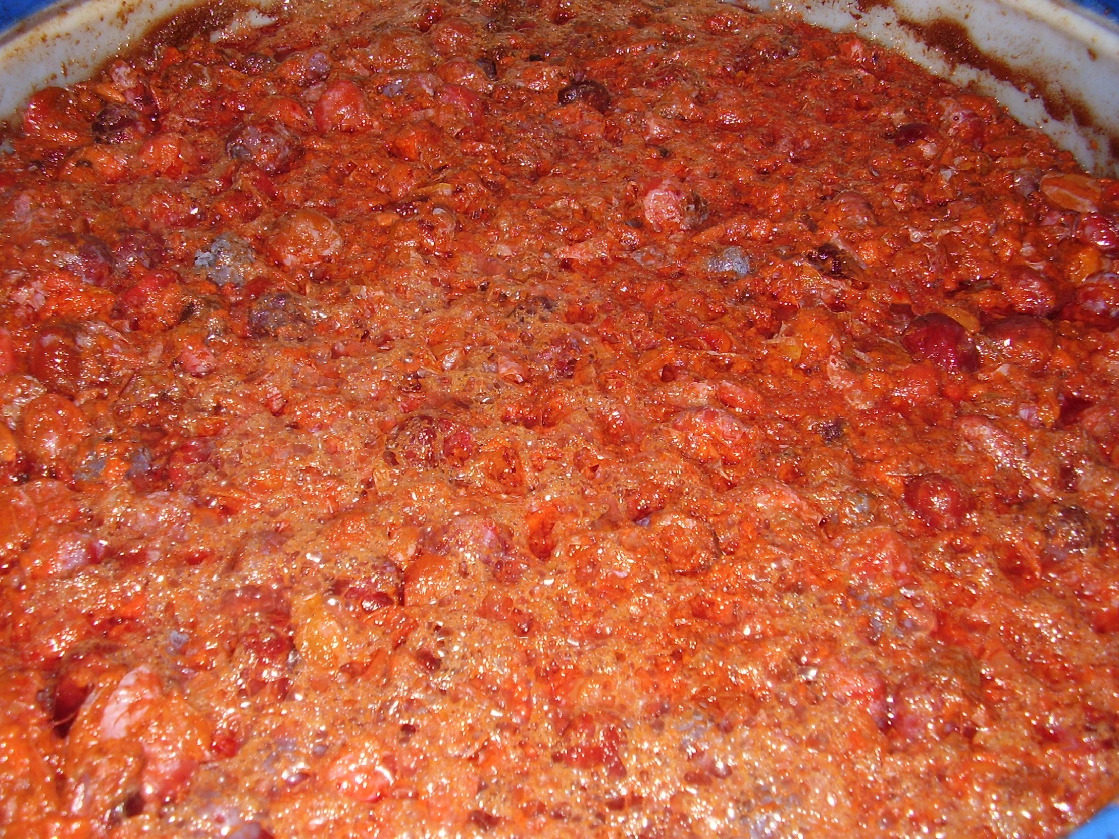 a dish filled with chili and seasonings in a bowl
