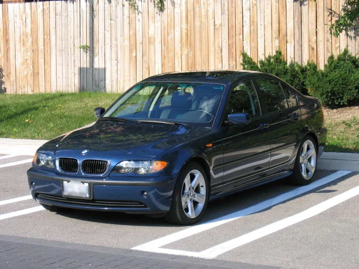 black bmw with white trim parked in a parking lot