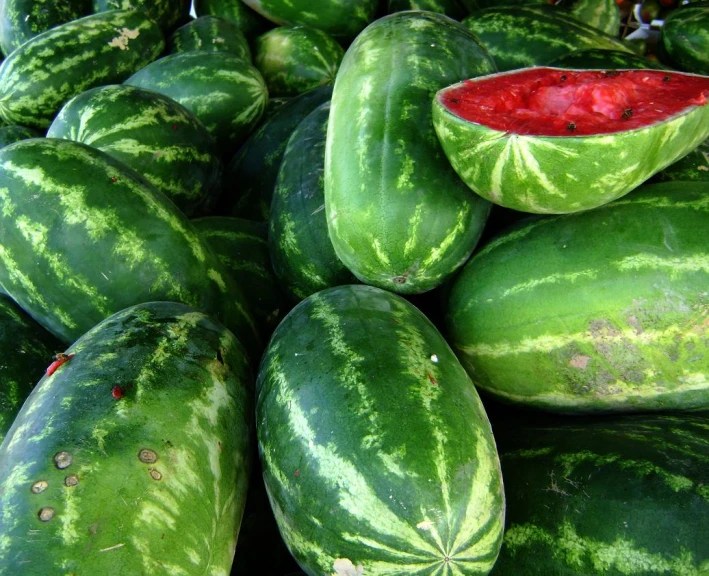 some very large bunches of watermelon that have been sliced and put together