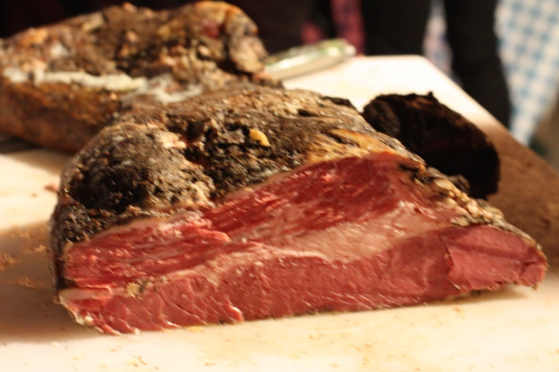 two pieces of meat sitting on top of a white counter