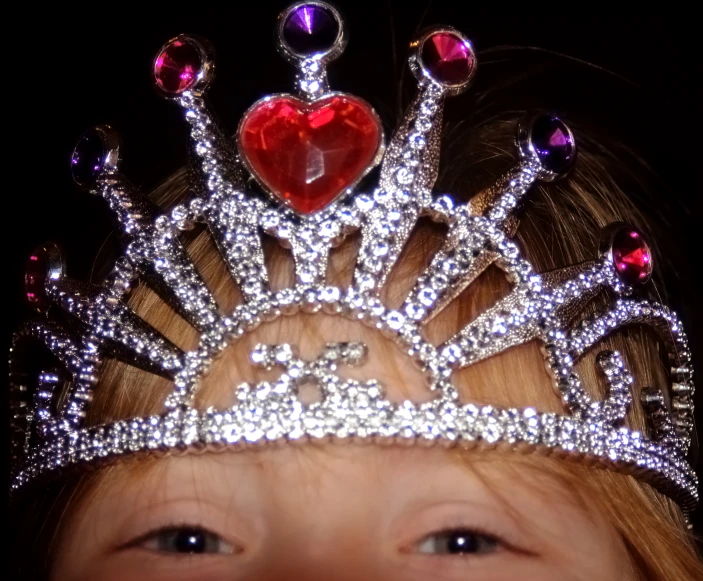 a child wearing a tiara on their head