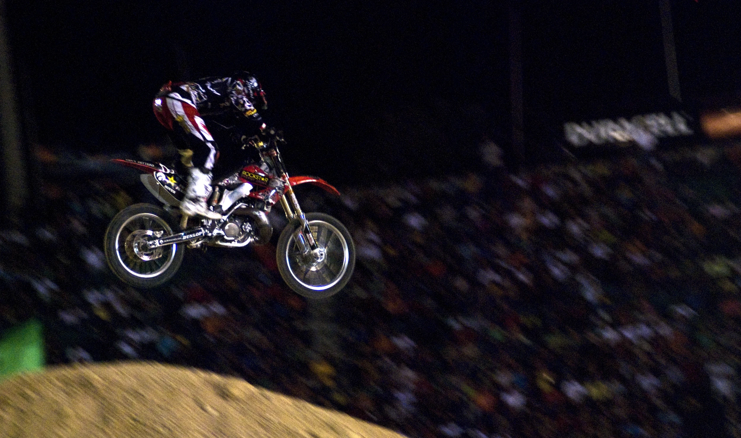 a person in the air on a motor bike at a competition