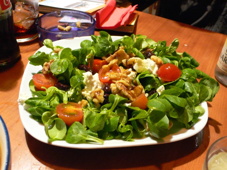 a plate with some salad on a table