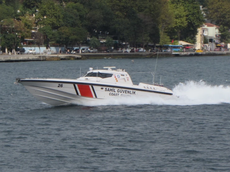 a boat speeds through a large body of water