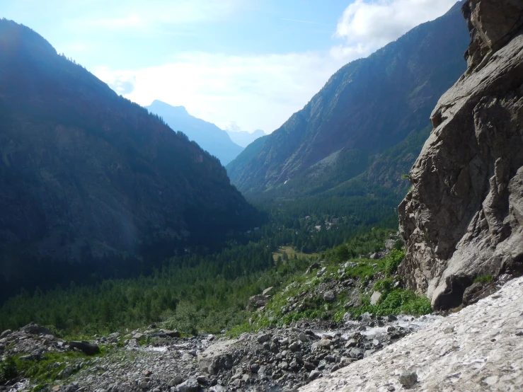 the rocks on the side of a mountain and the woods to the side