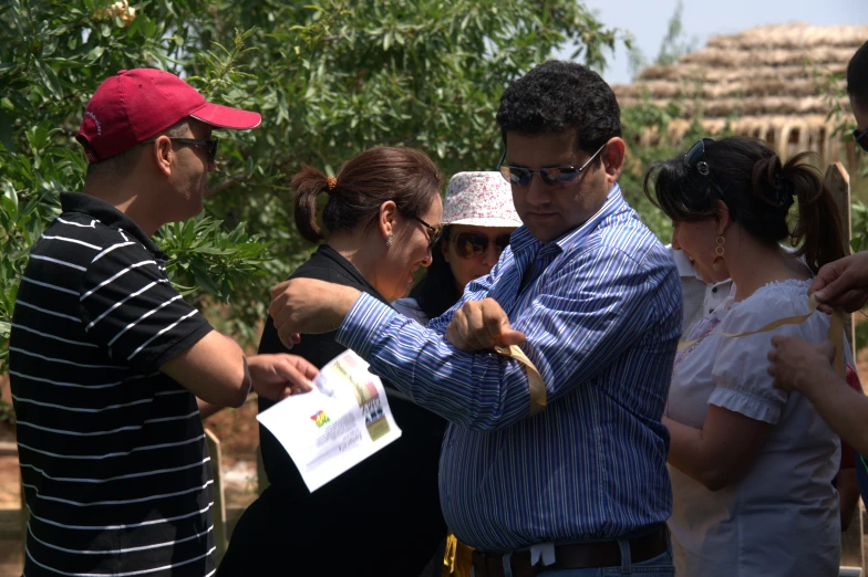 a man showing soing to people on a group