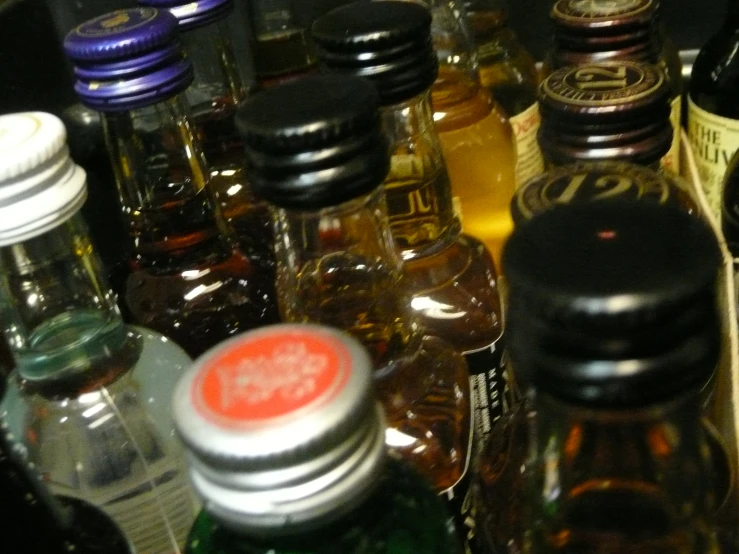 a counter with bottles filled with liquid and oils