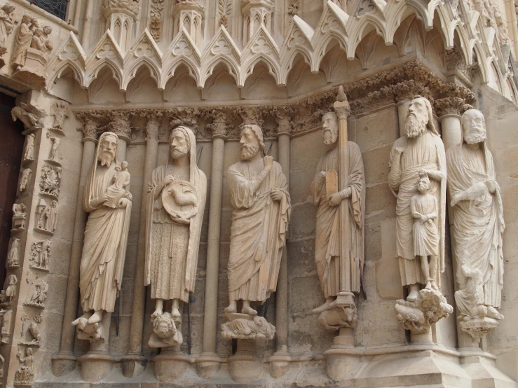 a group of statues is shown near the entrance of an old building