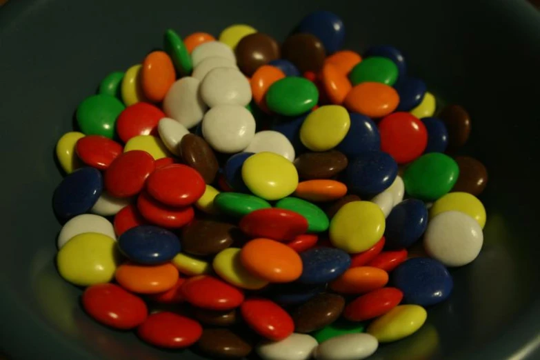 a black plate full of some very cute colorful candy