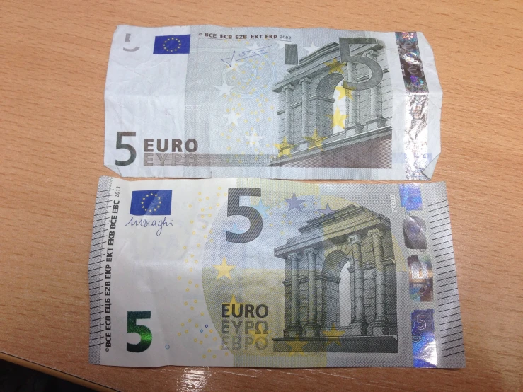 some euro bills folded up on a table