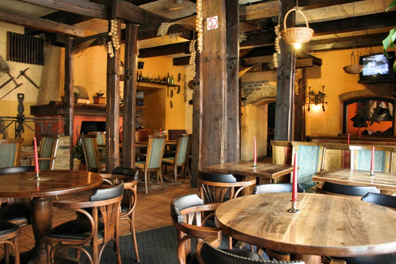 the restaurant has an interesting wood ceiling and many tables