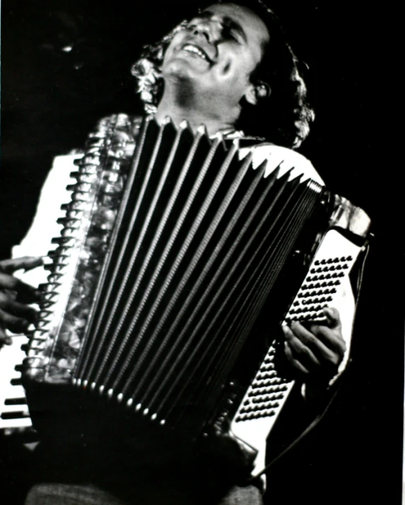 a man with an accordion in front of him smiling