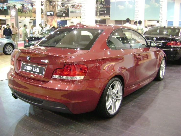 a red bmw is shown parked on a display floor
