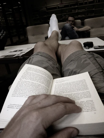 a person with a book in their lap reading