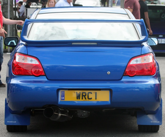 a blue sports car with an inscription on the back