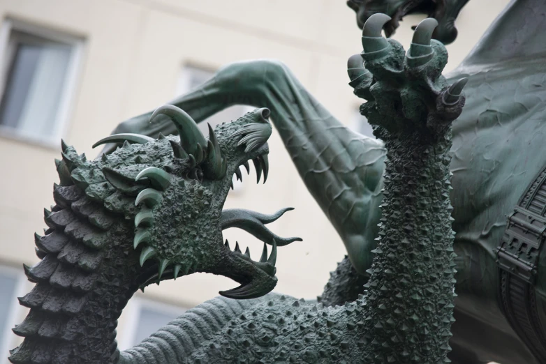 an artistic dragon statue standing in front of a building