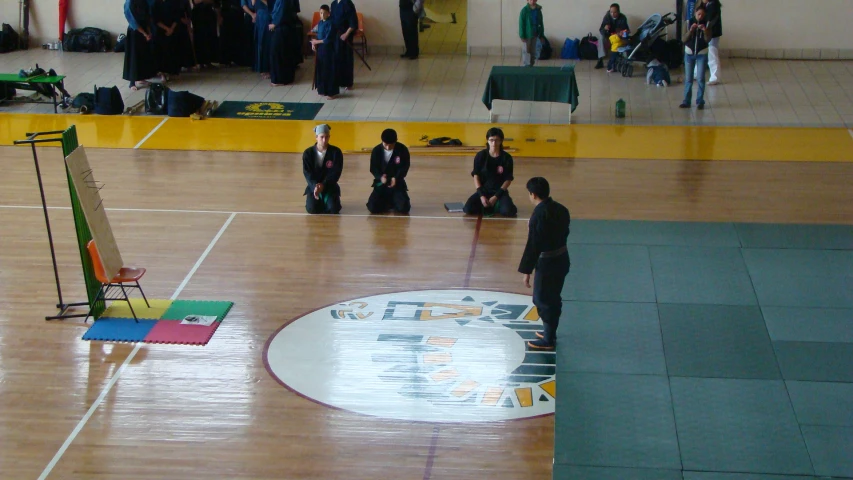 people watching a display in a gymnasium with an overpass