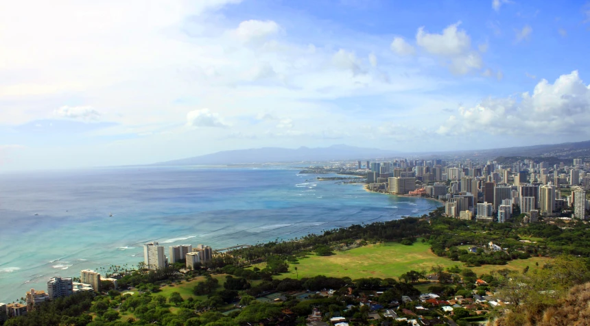 a panoramic view of a large city, ocean and mountains