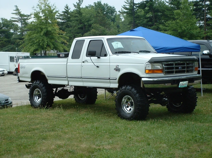 a large white truck parked in the grass