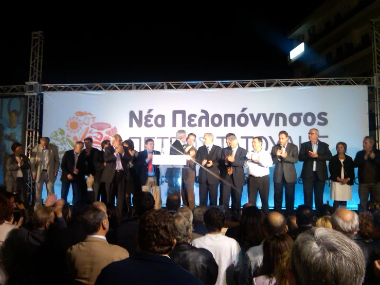 a bunch of men on stage posing for a group po