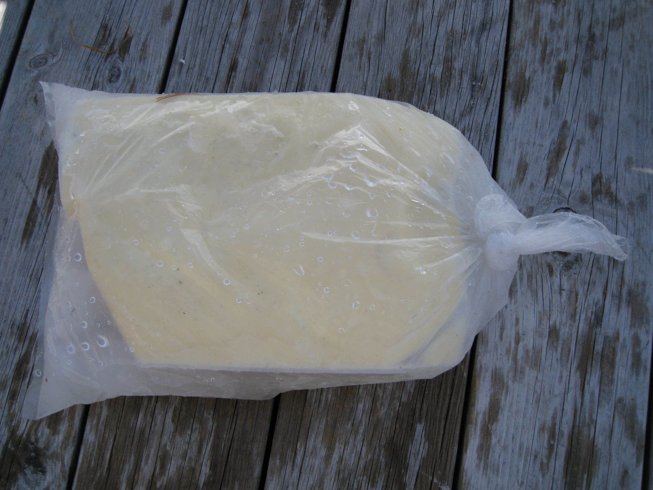 a plastic wrapper is being used to wrap up a doughnut