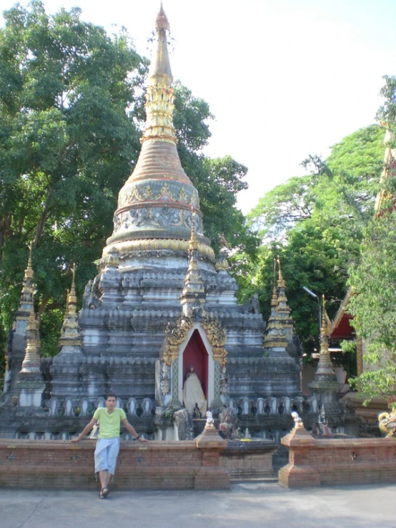 a woman standing next to an elaborately designed temple