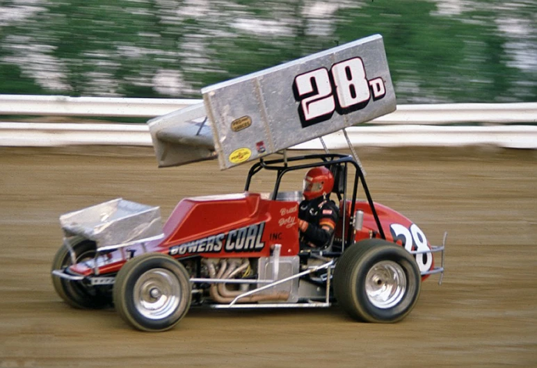 a person drives a dirt buggy on a track