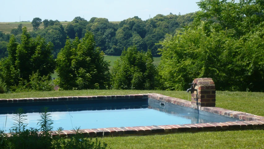 a pool is shown with trees in the background