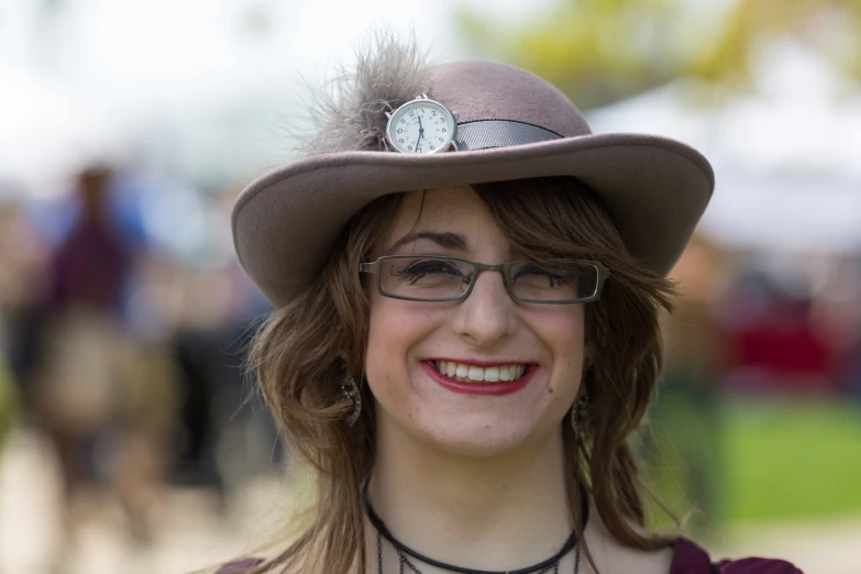 a woman with a hat that has a clock on it