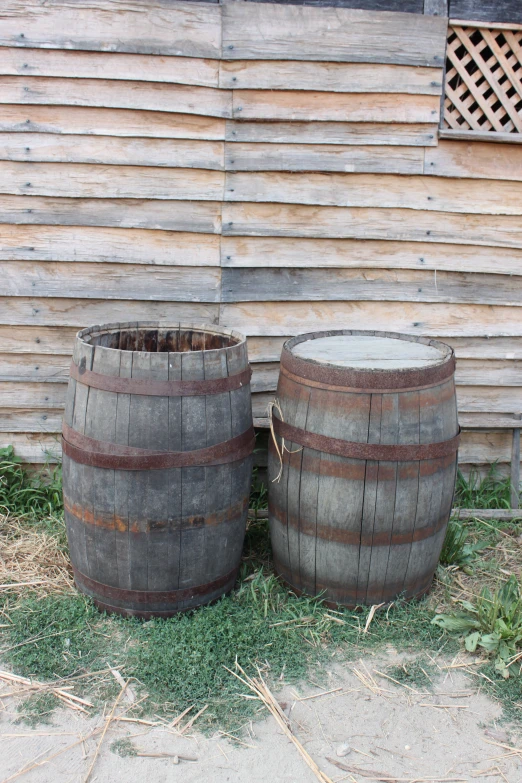 two wine barrels sit in front of a building