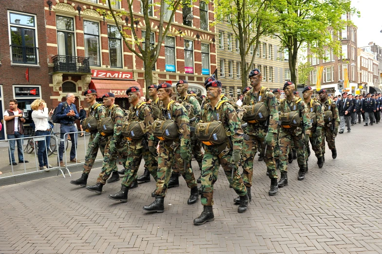 several soldiers are marching along the street in formation