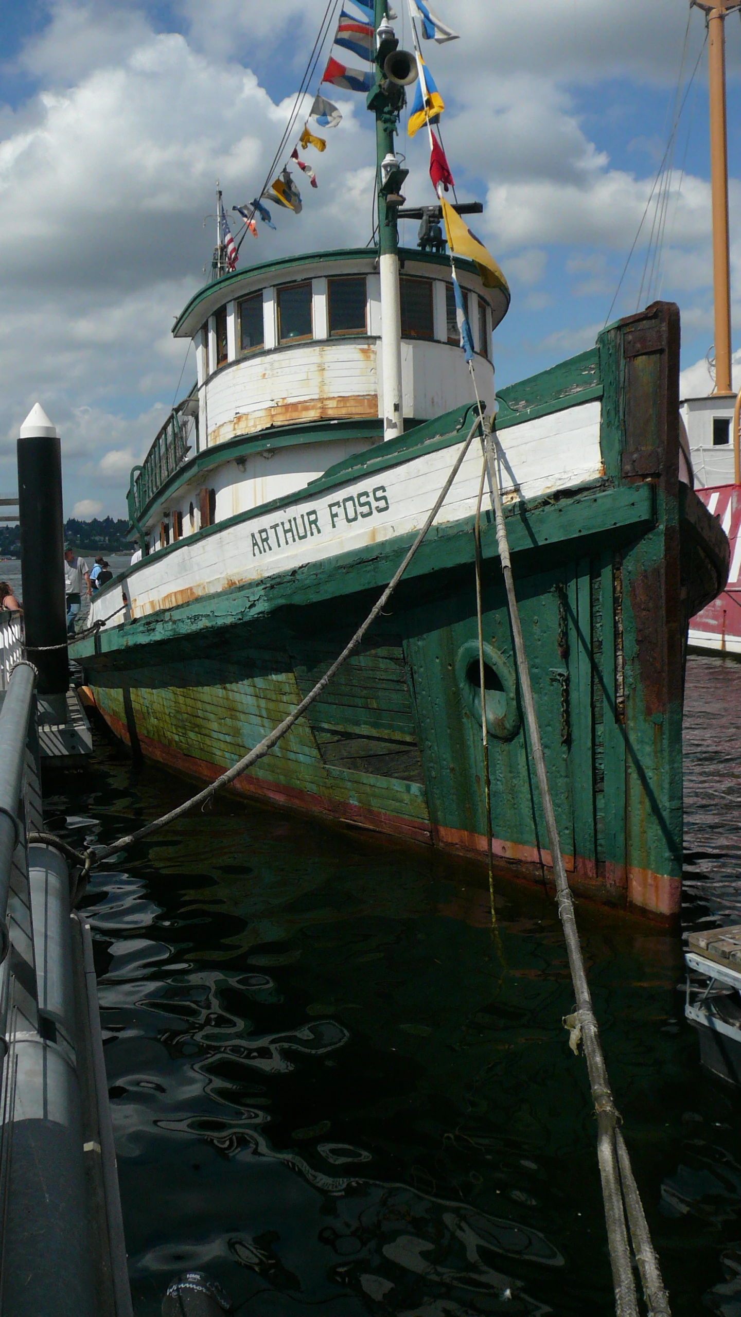 a large white and green boat sitting next to a dock