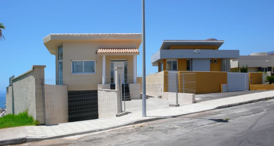 a small house sits by the curb in front of a beach