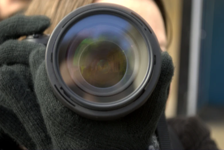 a woman in green sweater taking a po with her camera